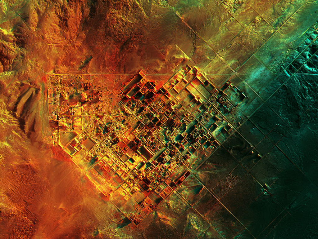 AI visualization of radar imagery: buried city walls and a street grid glowing under desert sand.